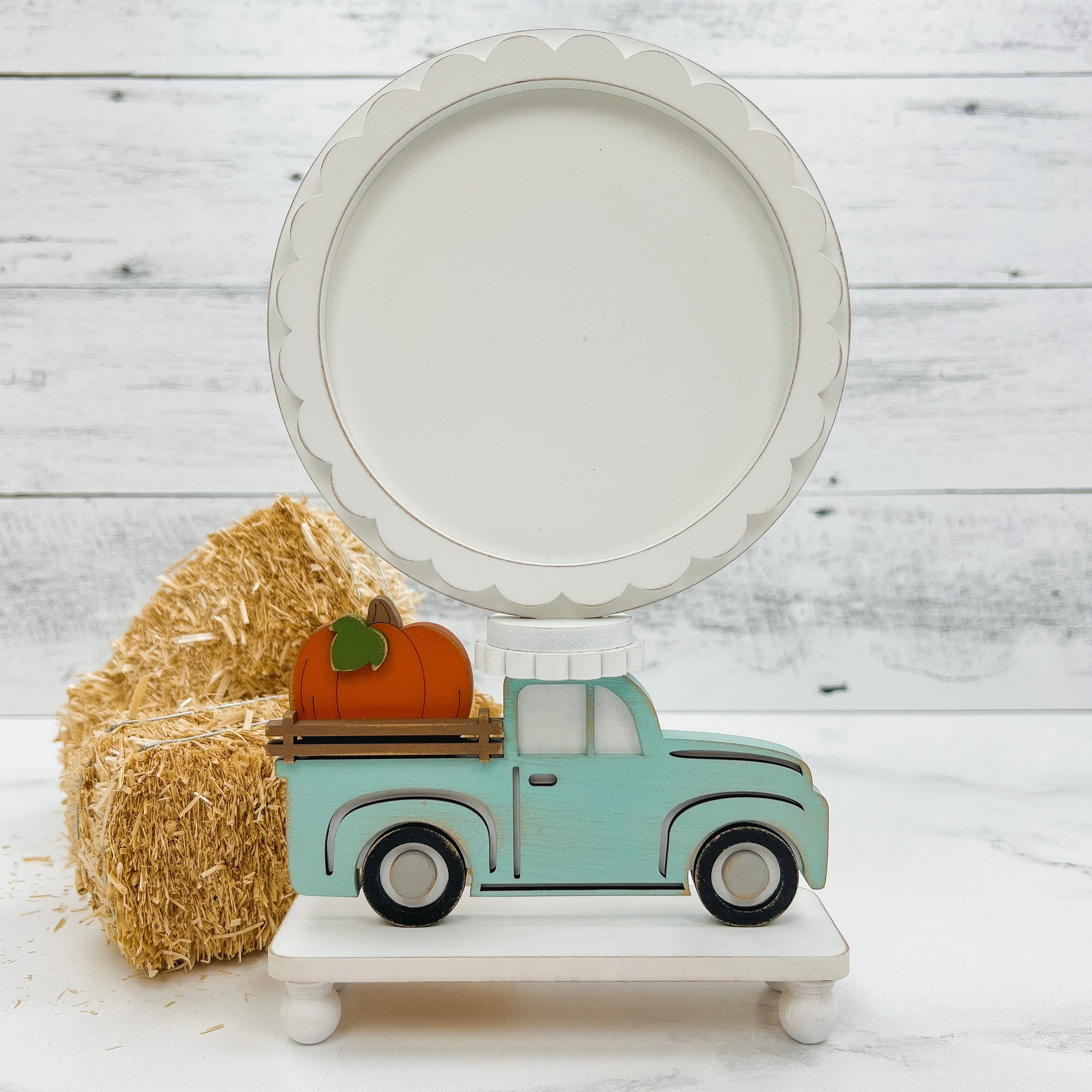 Truck with pumpkin wood pedestal frame for diplaying a finished cross stitch piece. Wood cross stitch diplay backer. 