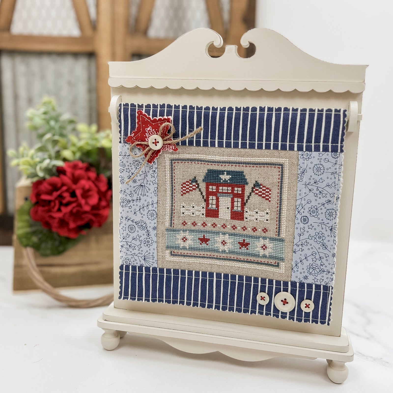 Unfinished Quiltkeeper wood display for cross stitch finishes and small quilt blocks, styled like a vintage quilt rack with fabric finishing.