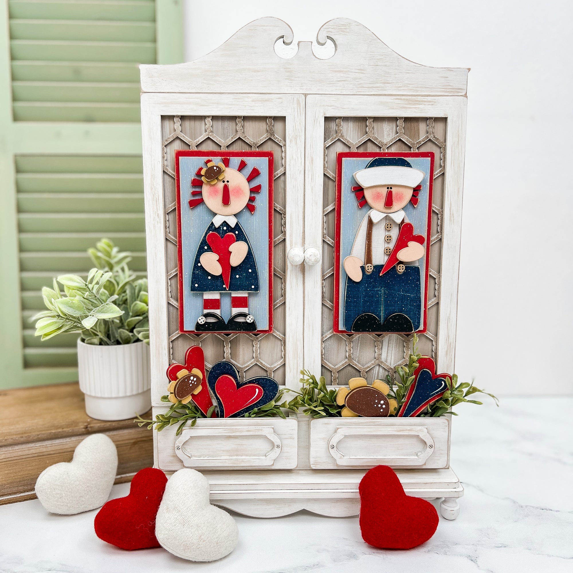 Raggedy Ann and Andy displayed on a wood country cabinet home decoration.