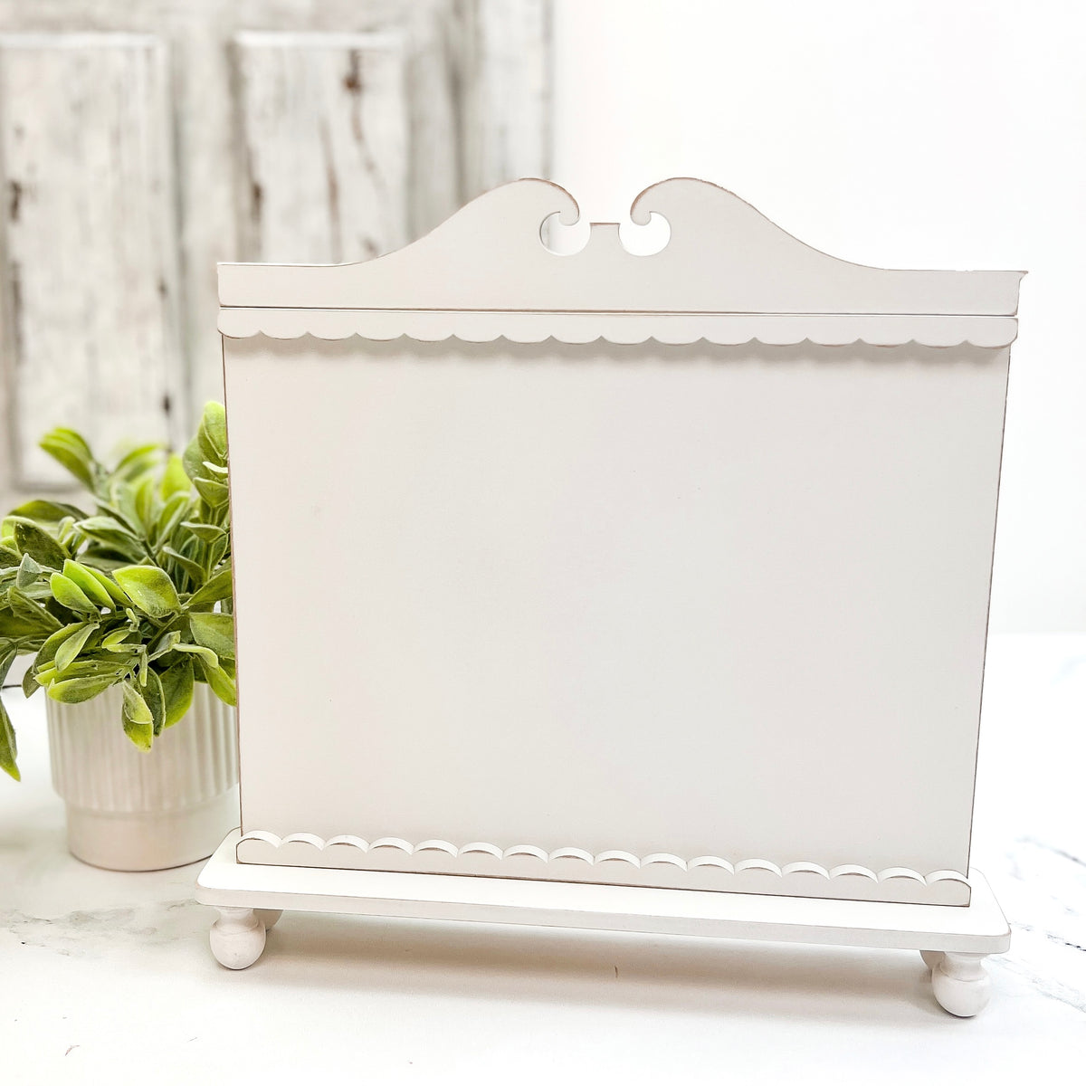 Unfinished white wood Seasonal Samplings cross stitch display with scalloped trim and decorative feet.