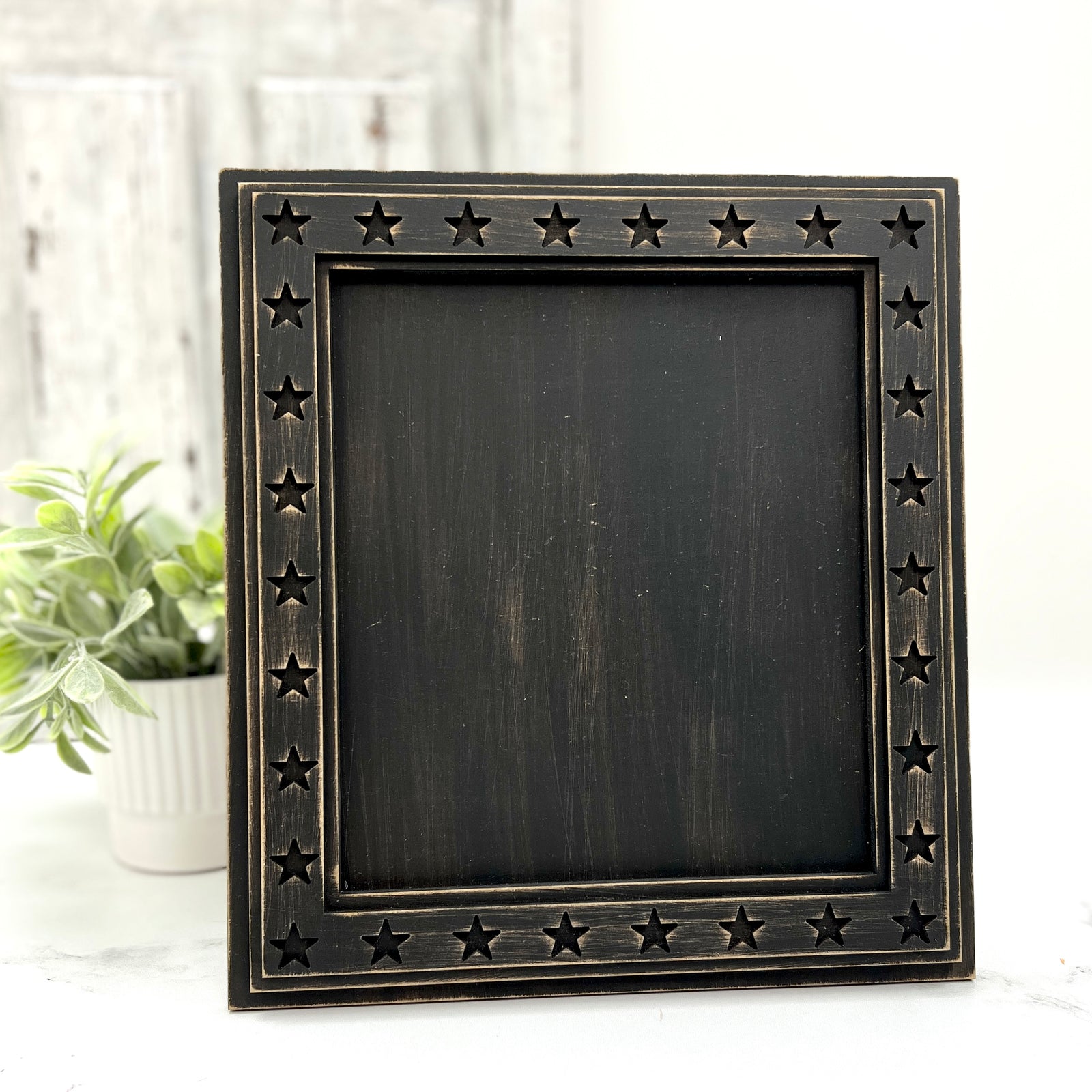 Rustic square wooden cross stitch display frame with cut-out star border and distressed farmhouse finish