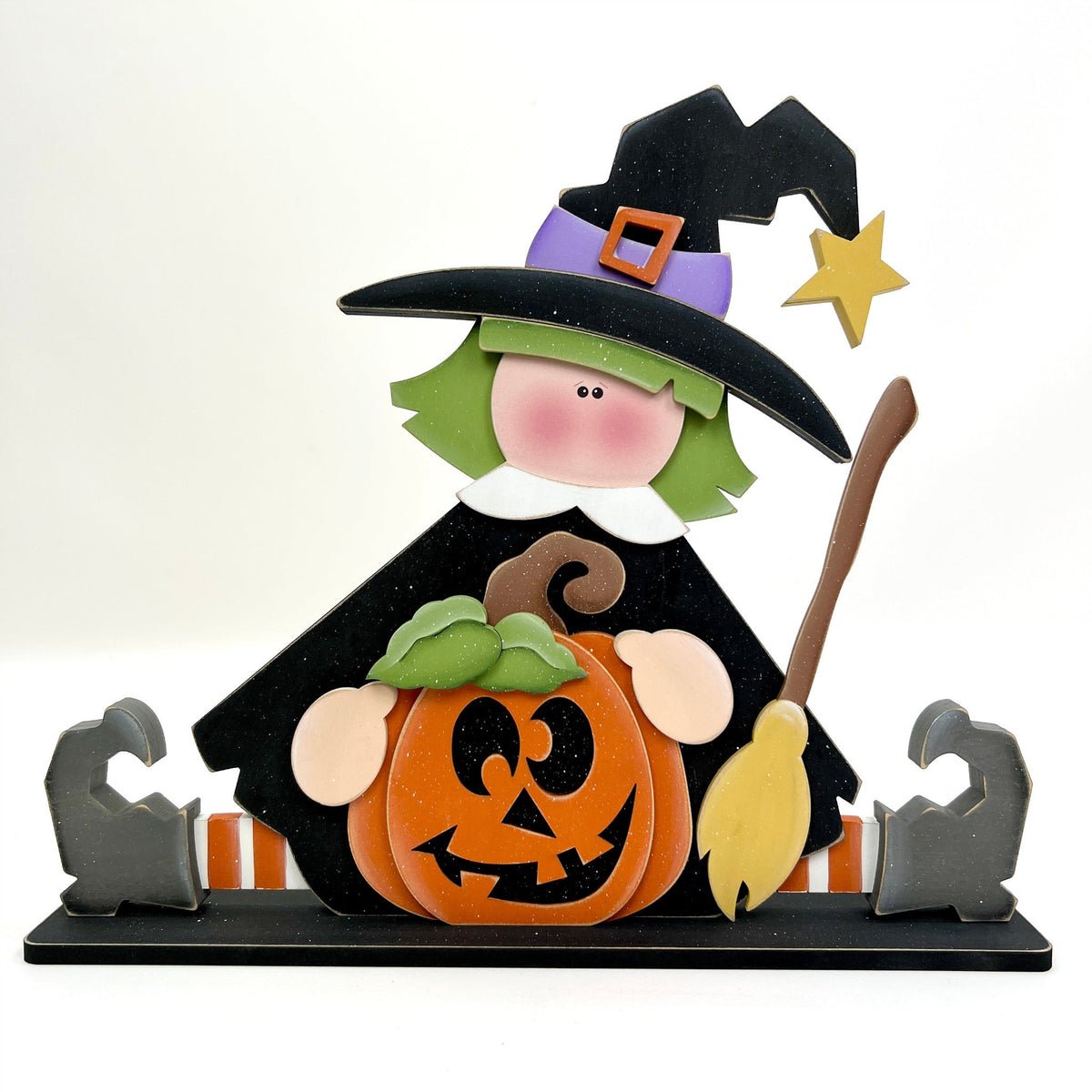Sitting witch holding a pumpkin wood decor 