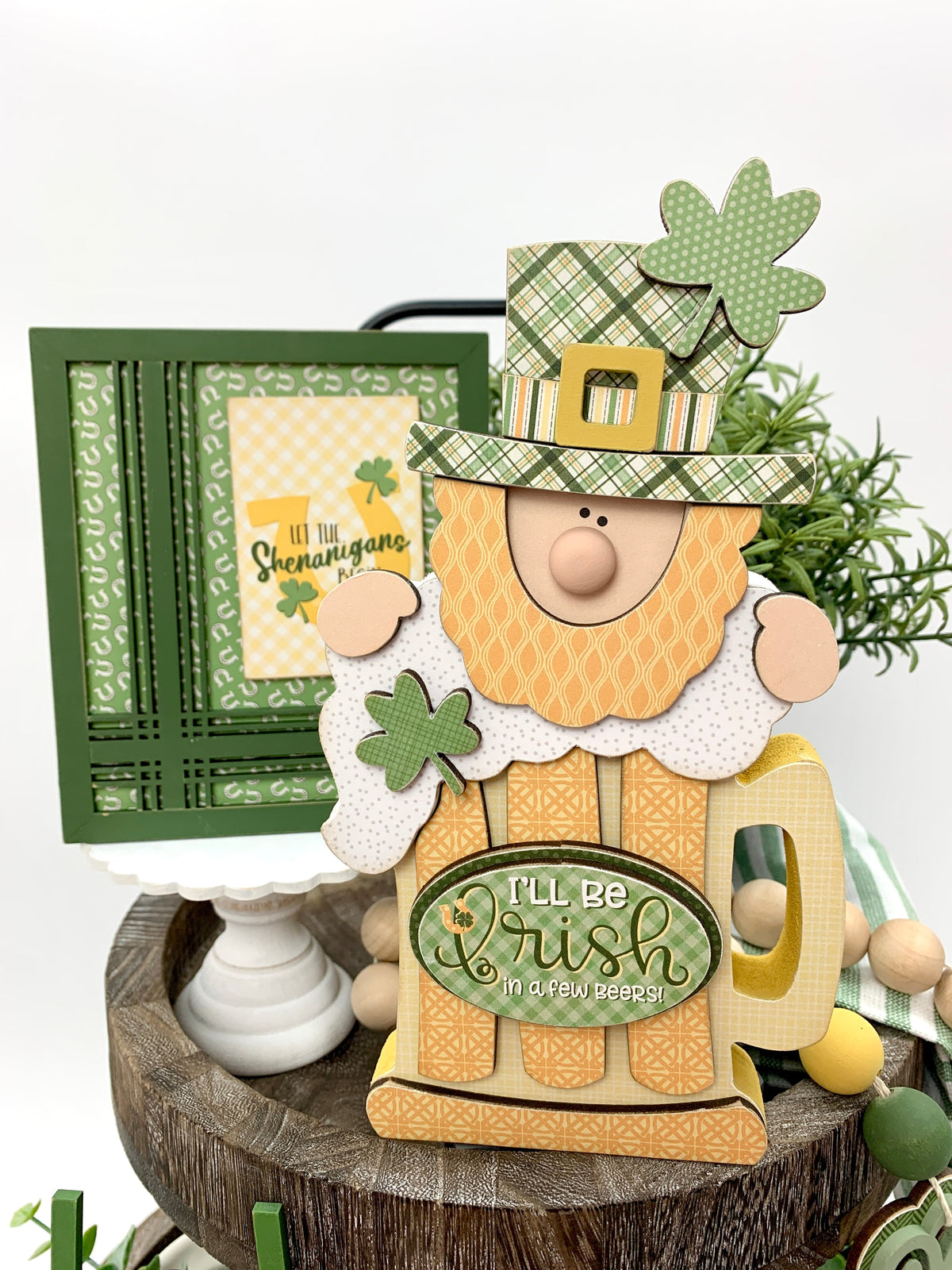 St. Patrick&#39;s Leprechaun with beer wood decoration on tiered tray close up