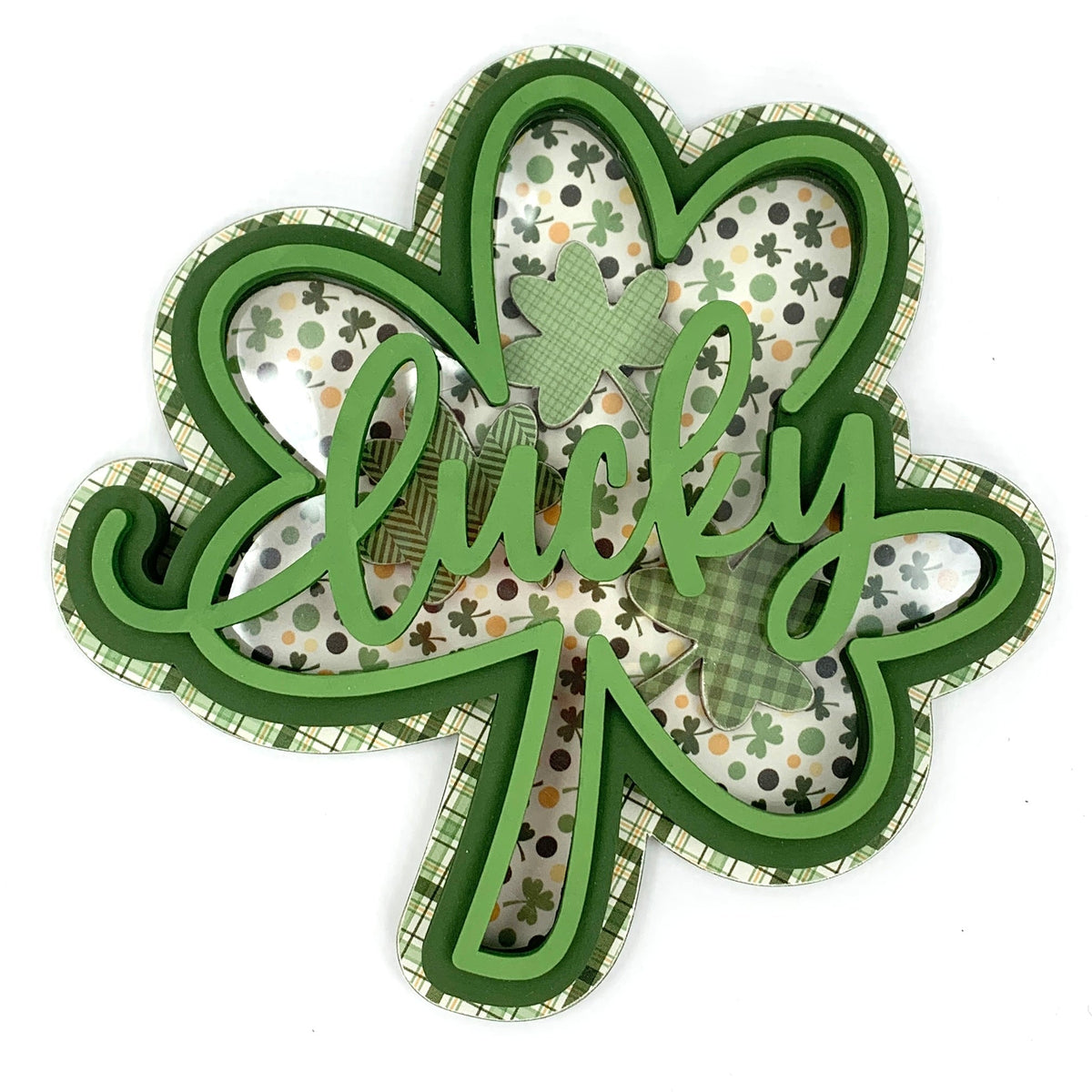Green wood shamrock with the word lucky filled with small shamrocks.