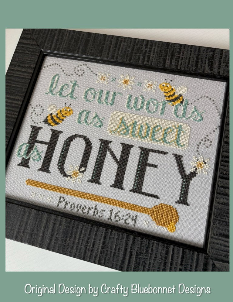 Cross-stitched design with bees and text 'Let our words be as sweet as honey' Proverbs 16:24