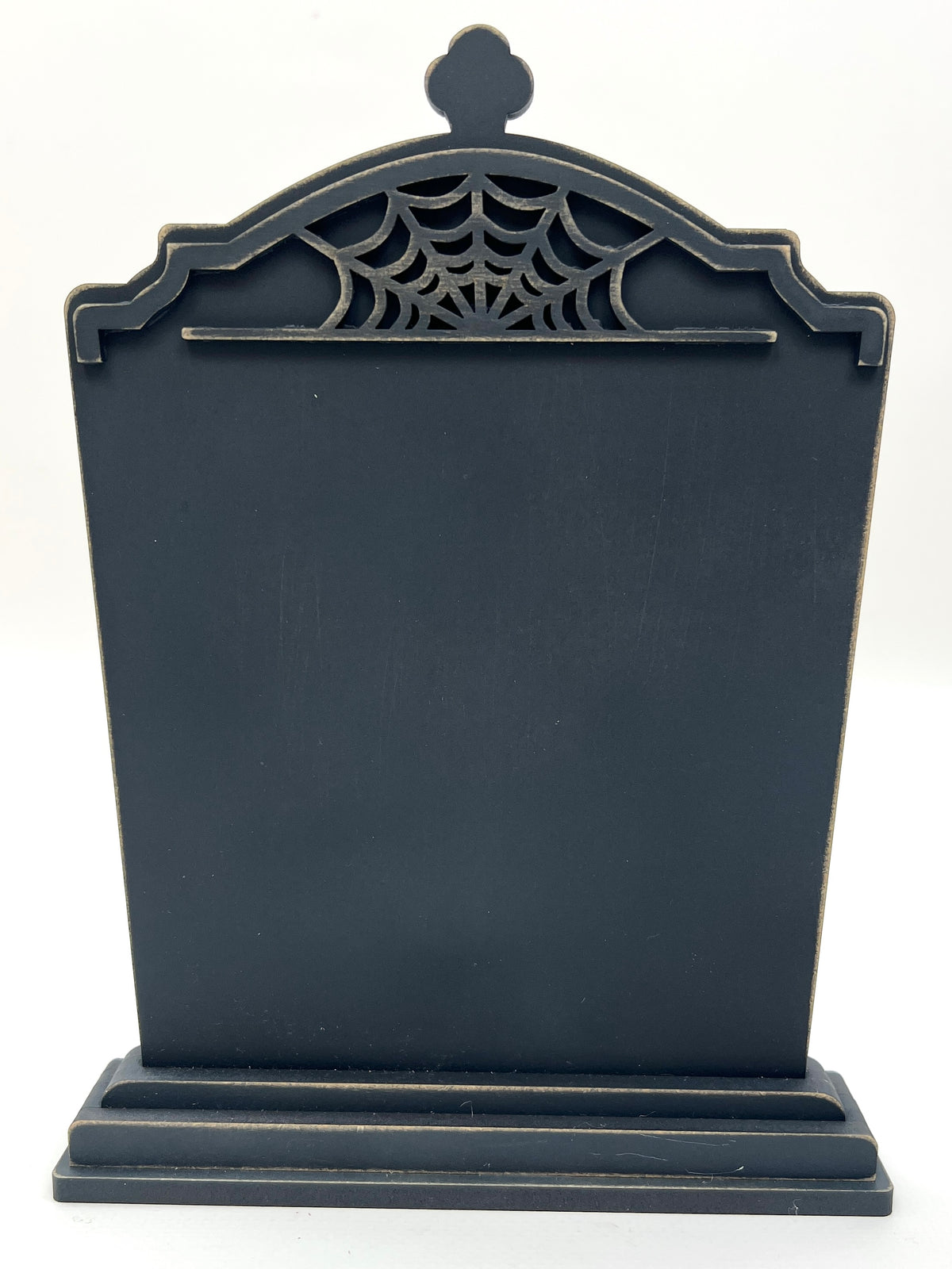 Black Halloween tombstone with spider web design on a white background