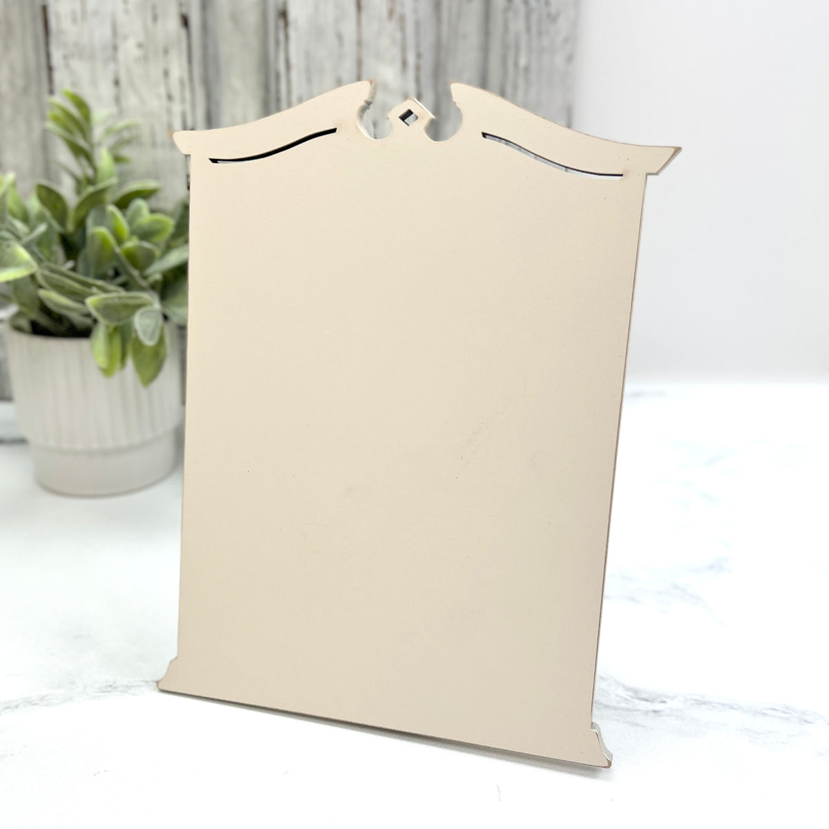 Pre painted cream Tall Traditional Cross Stitch Display with a classic shaped top, decorative cutout details, and lightly distressed edges.