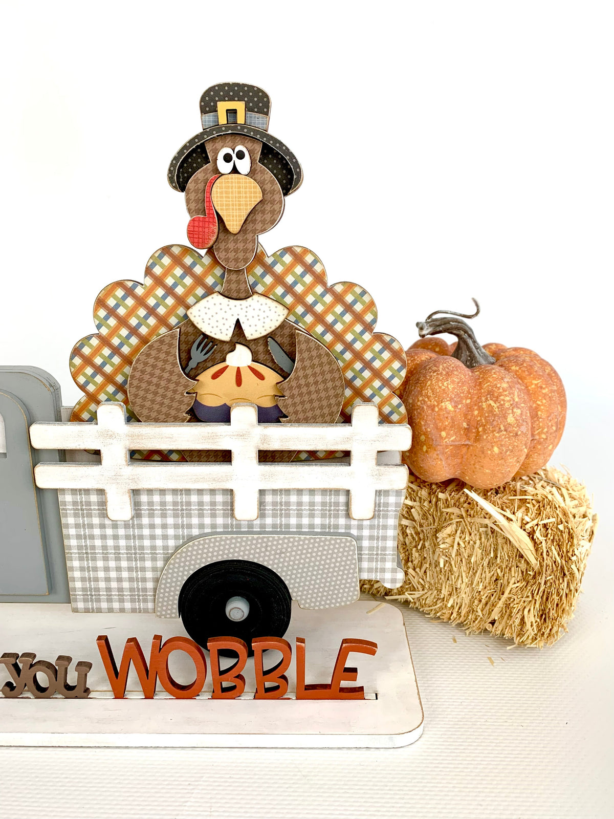 Interchangeable truck with a turkey insert and gobble til you wobble phrase. Interchageable wood truck with chnaging seasonal inserts.  Close up view
