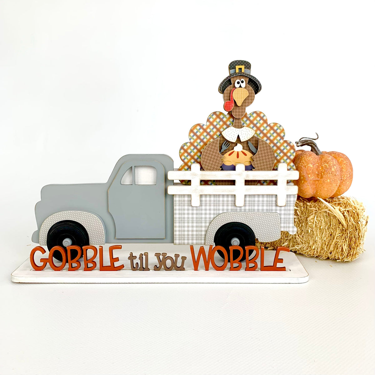 Interchangeable truck with a turkey insert and gobble til you wobble phrase. Interchageable wood truck with changing seasonal inserts