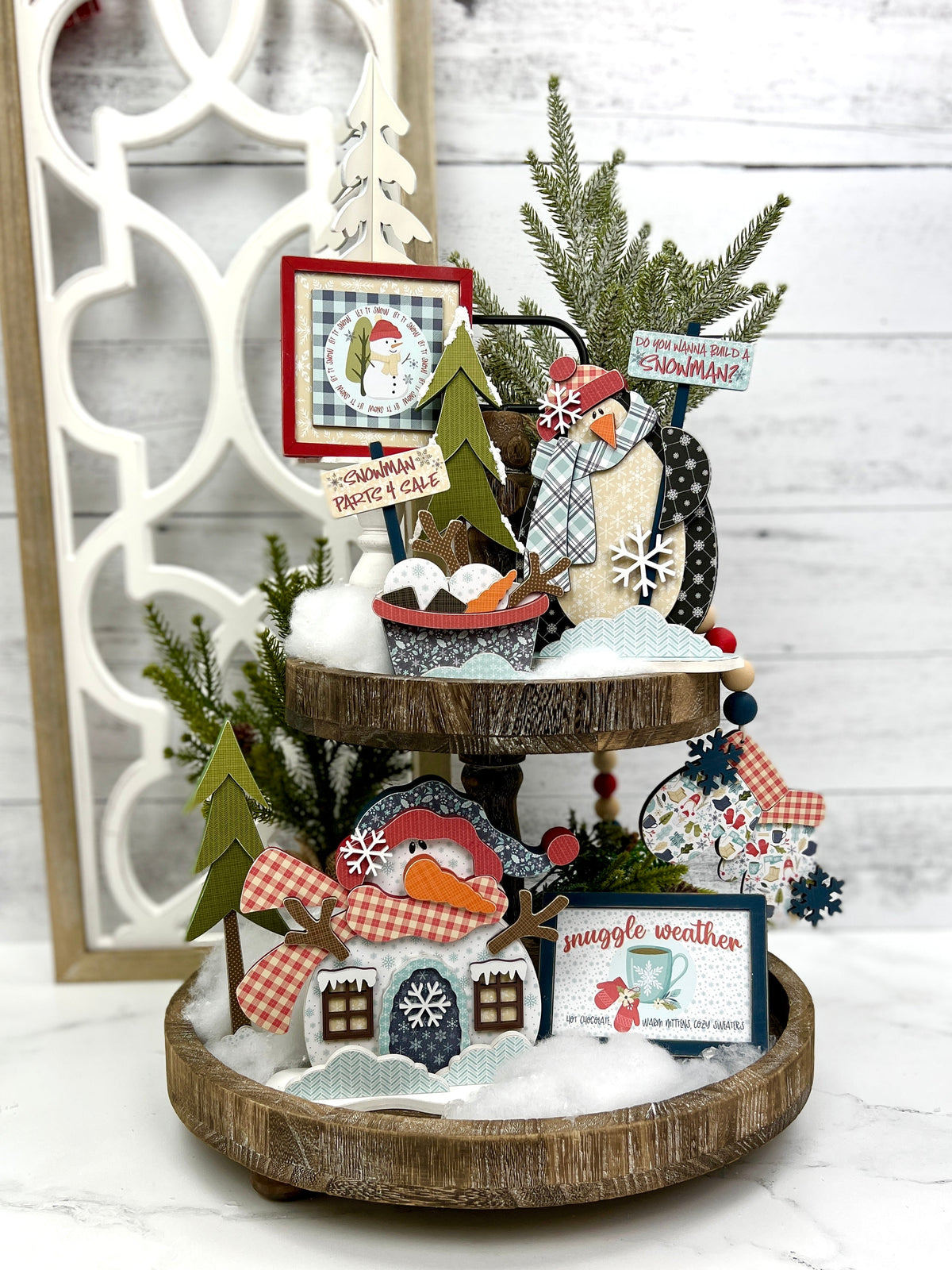 winter themed tiered tray wood decorations with penguin, snowman, garland and winter signs.