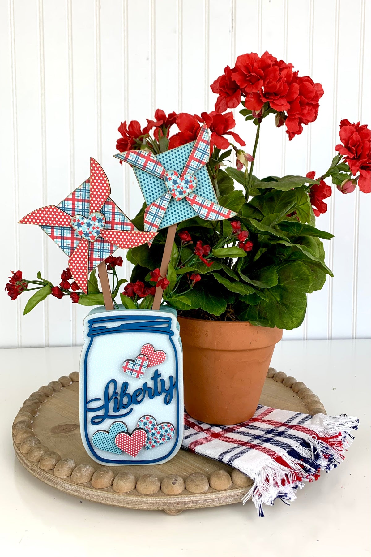 4th of July themed mason jar with patriotic pinwheels