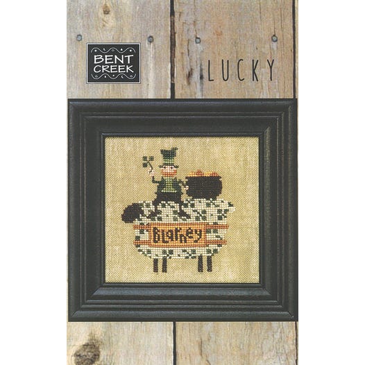 cross-stitched St Patrick&#39;s Day gold toting Leprechaun riding a shamrock sheep