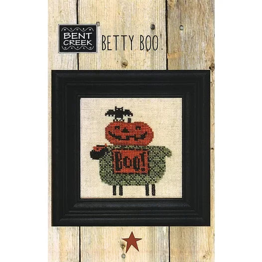 Cross-stitched masked sheep with a pumpkin and black bat