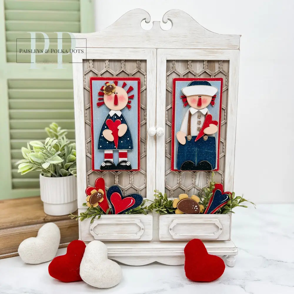 Raggedy Ann and Andy displayed on a wood country cabinet home decoration.