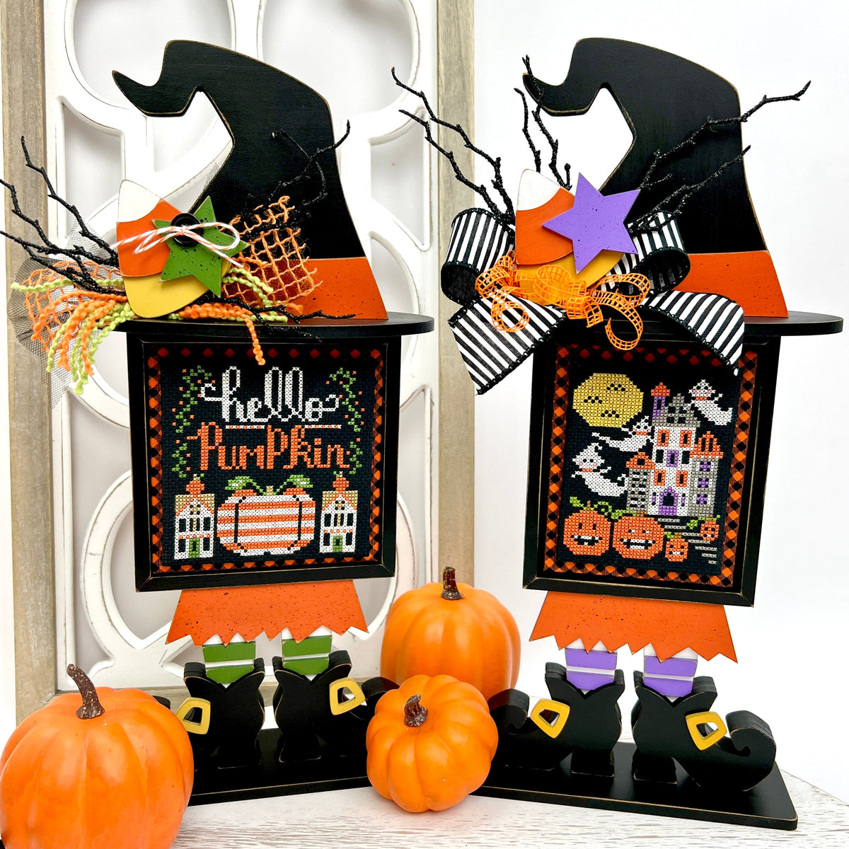 Wood witches with Stitching with the Housewives Halloween cross stitch finished pieces displayed 