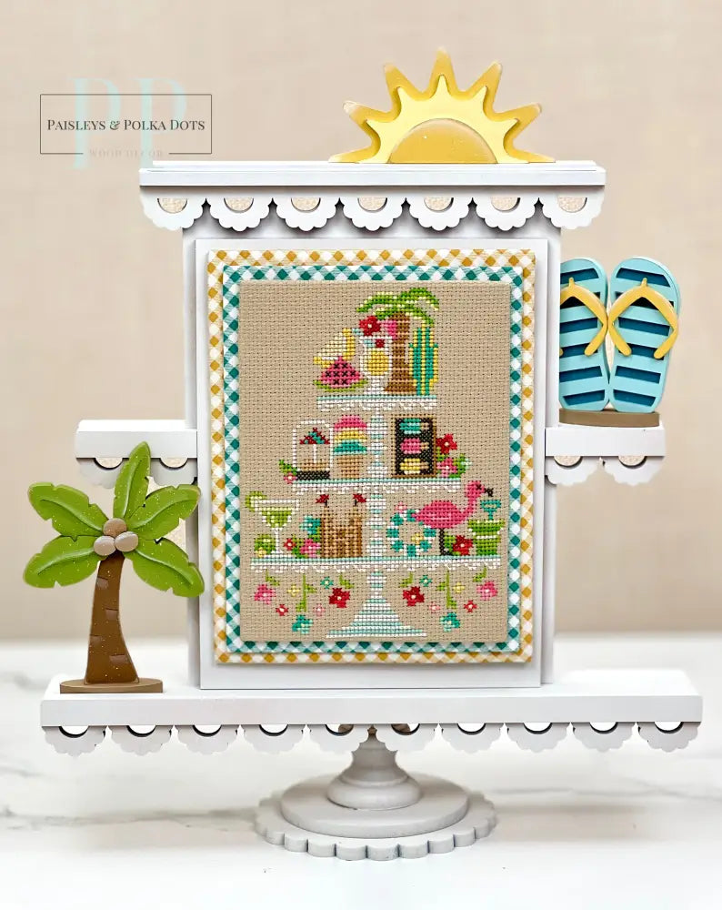 Summer themed faux tiered tray cross stitch display with a finished cross stitch by Erin Elizabeth designs.