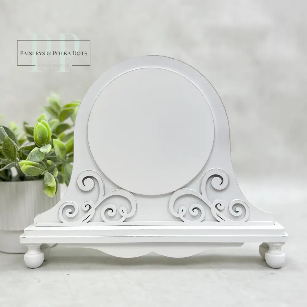 White wood cross stitch display backer for holding round cross stitch finishing.