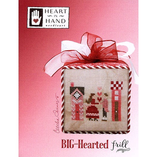 Cross-stitched fabric square with red ribbon on a pink background, featuring a courting couple with 'Heart in Hand' branding.