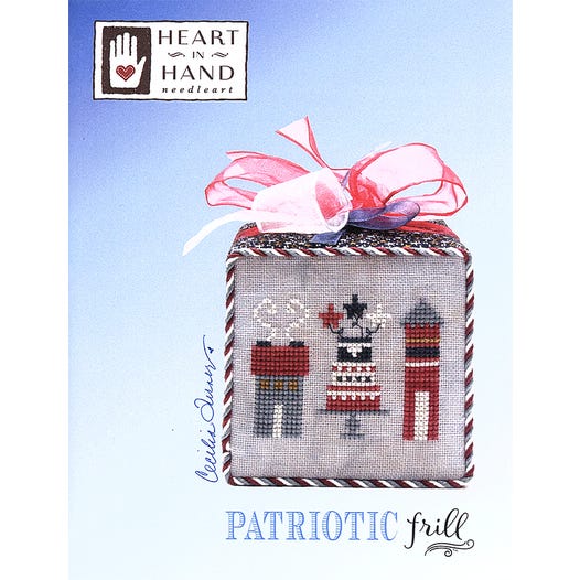 Cross-stitched design of a house, cake and firecracker 
