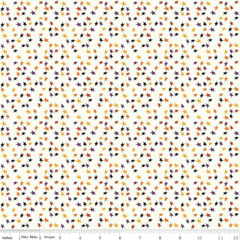 Pattern of small stars in orange, purple, yellow and black on a cream background.