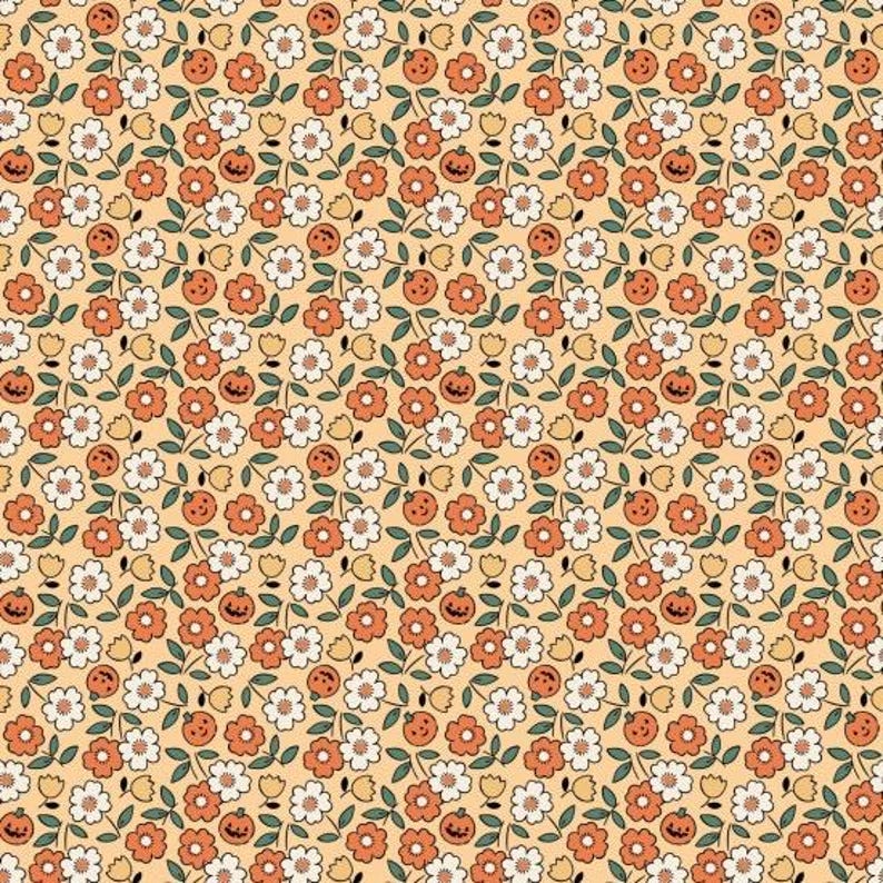 Pattern of small pumpkins and orange and white flowers on a yellow background