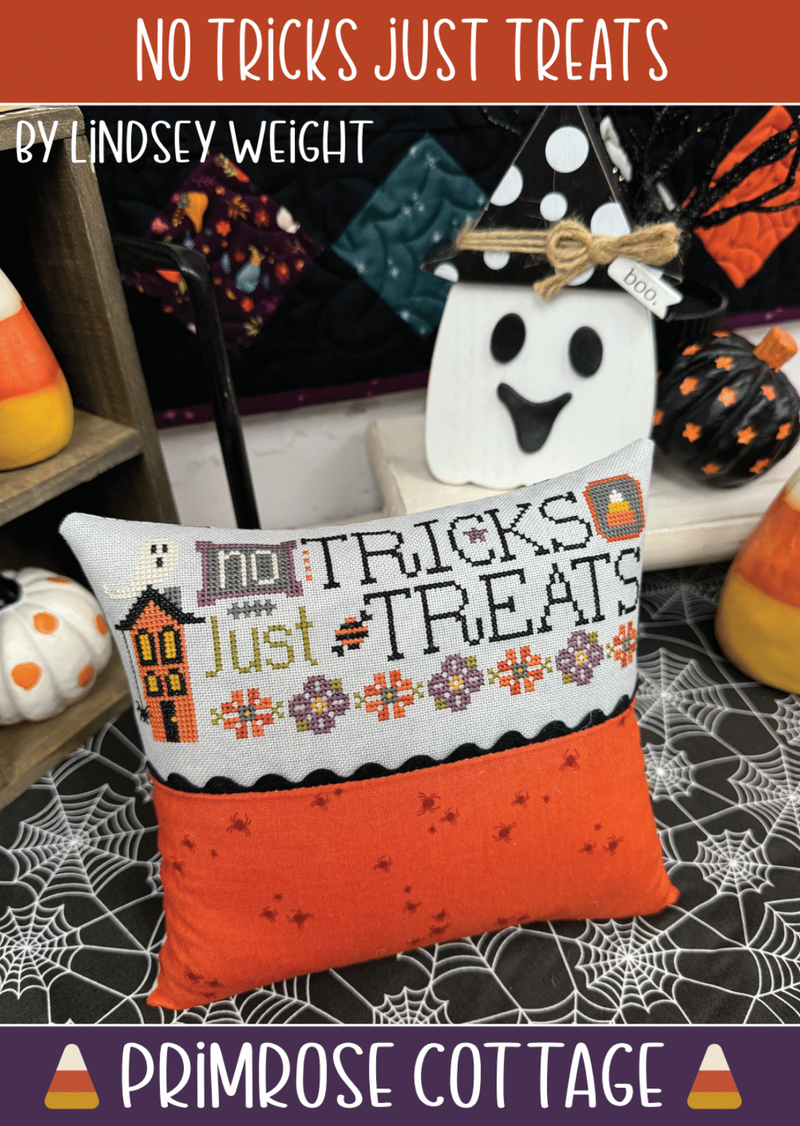 Halloween-themed pillow with 'No Tricks Just Treats' text, surrounded by candy corn and pumpkins.