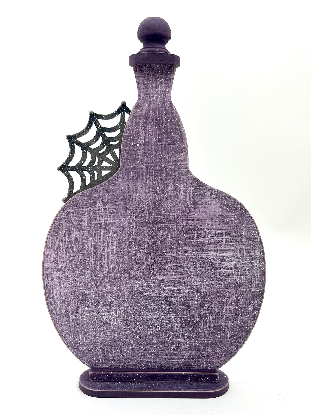 Decorative purple bottle with spider web design wood cross stitch display.