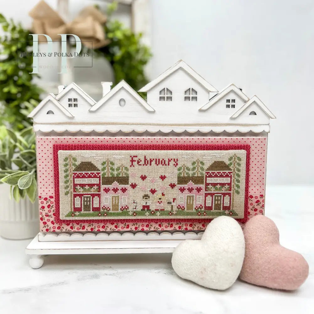 Roof top houses cross stitch display with Country Cottage Needleworks Jan Mini Village 
