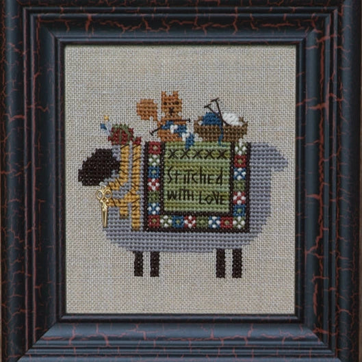 Cross-stitched sheep with decorative sewing and a squirrel