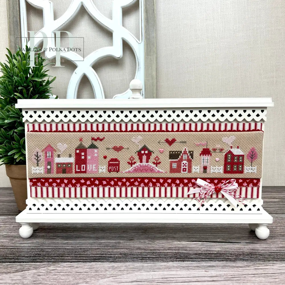 Big Hearted Tiny Town by Heart in Hand cross stitch on a wood decorative frame.