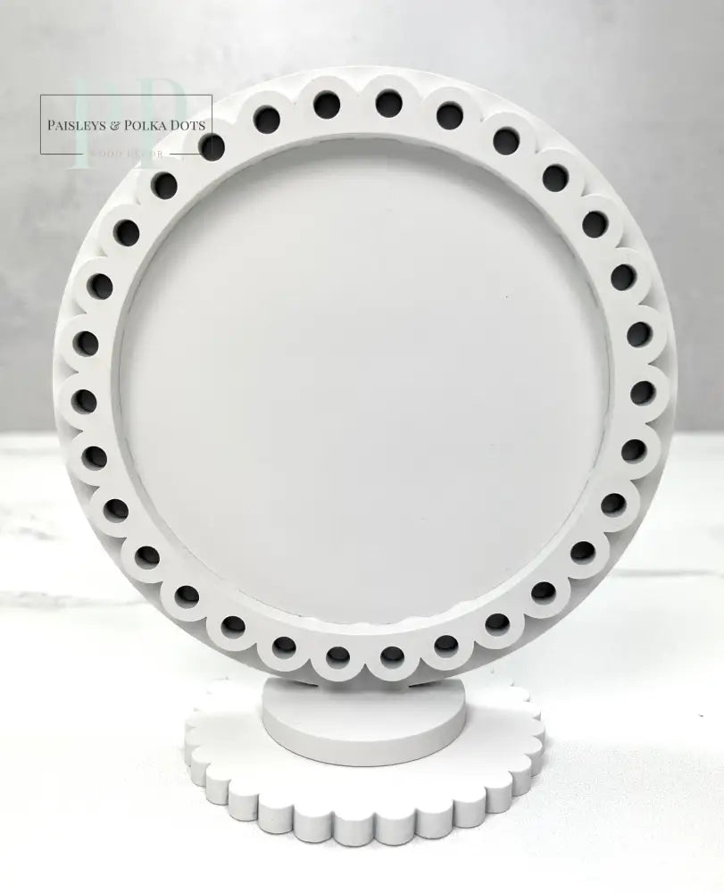 Round decorative wood frame for displaying finished cross stitch pieces