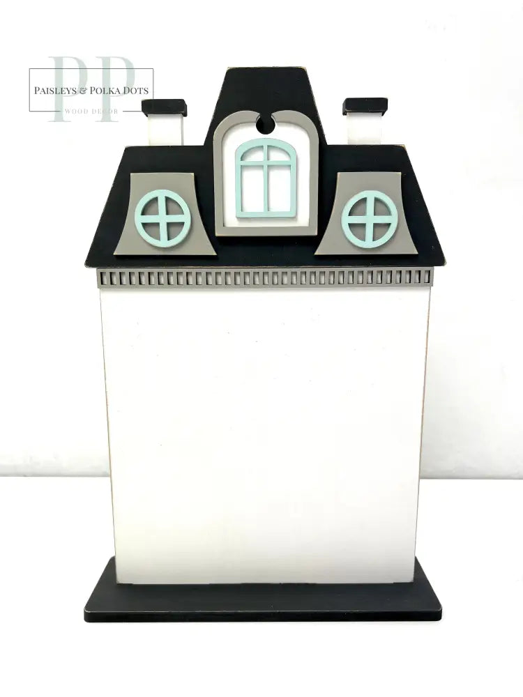 Victorian style house made of wood for displaying a finished cross stitch piece