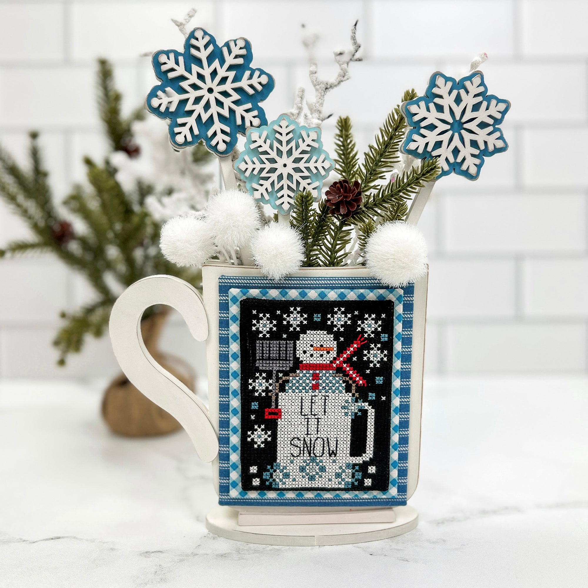 winter mug with snowflakes sticking out for displaying winter cross stitch finishes. Wood mug with snowflakes cross stitch display