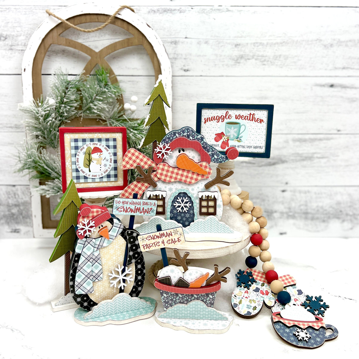 Winter wood craft decorations with snowman, penguin, mittens, and winter shiplap signs