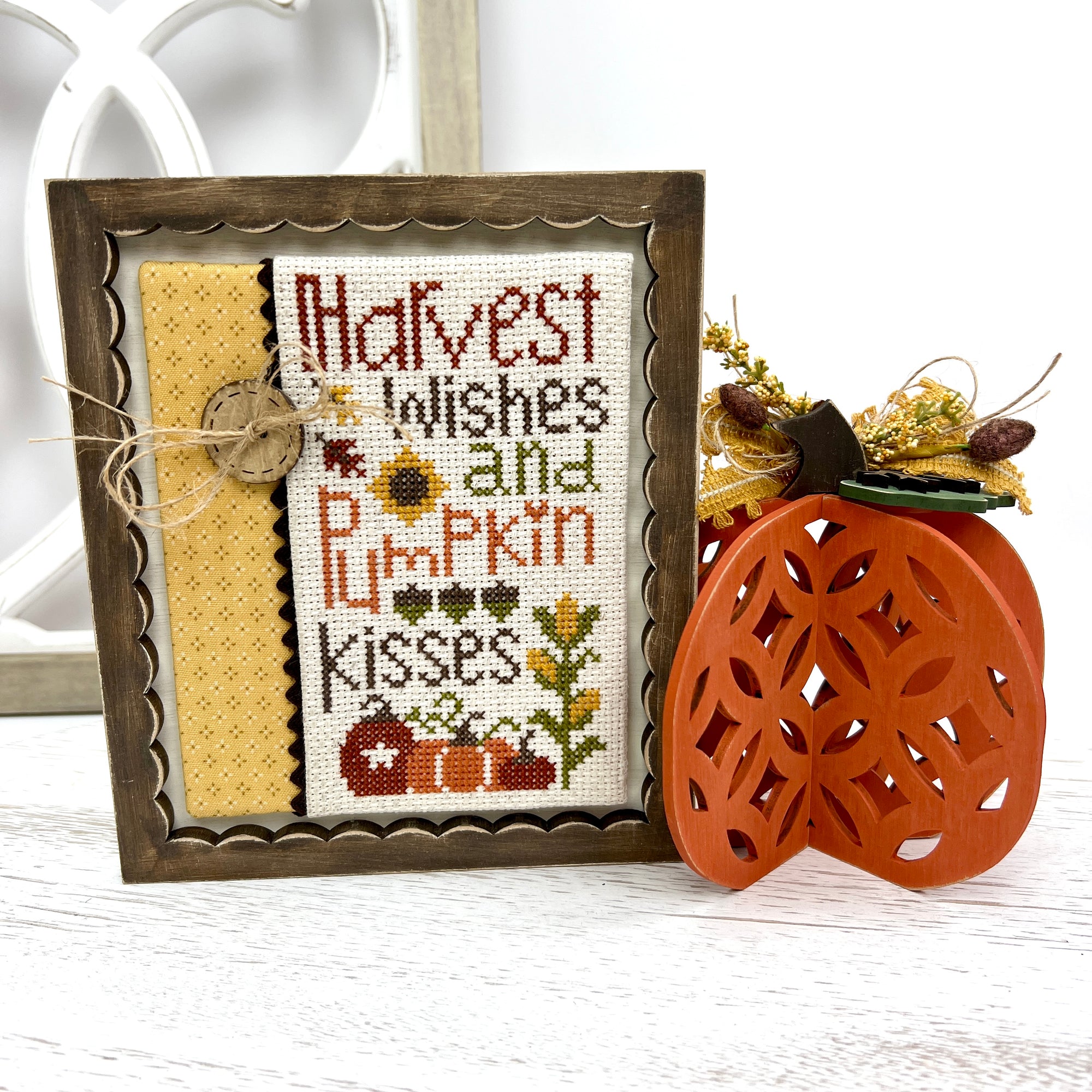 Fall pumpkin and frame with a fall cross stitch displayed wood decor craft kit