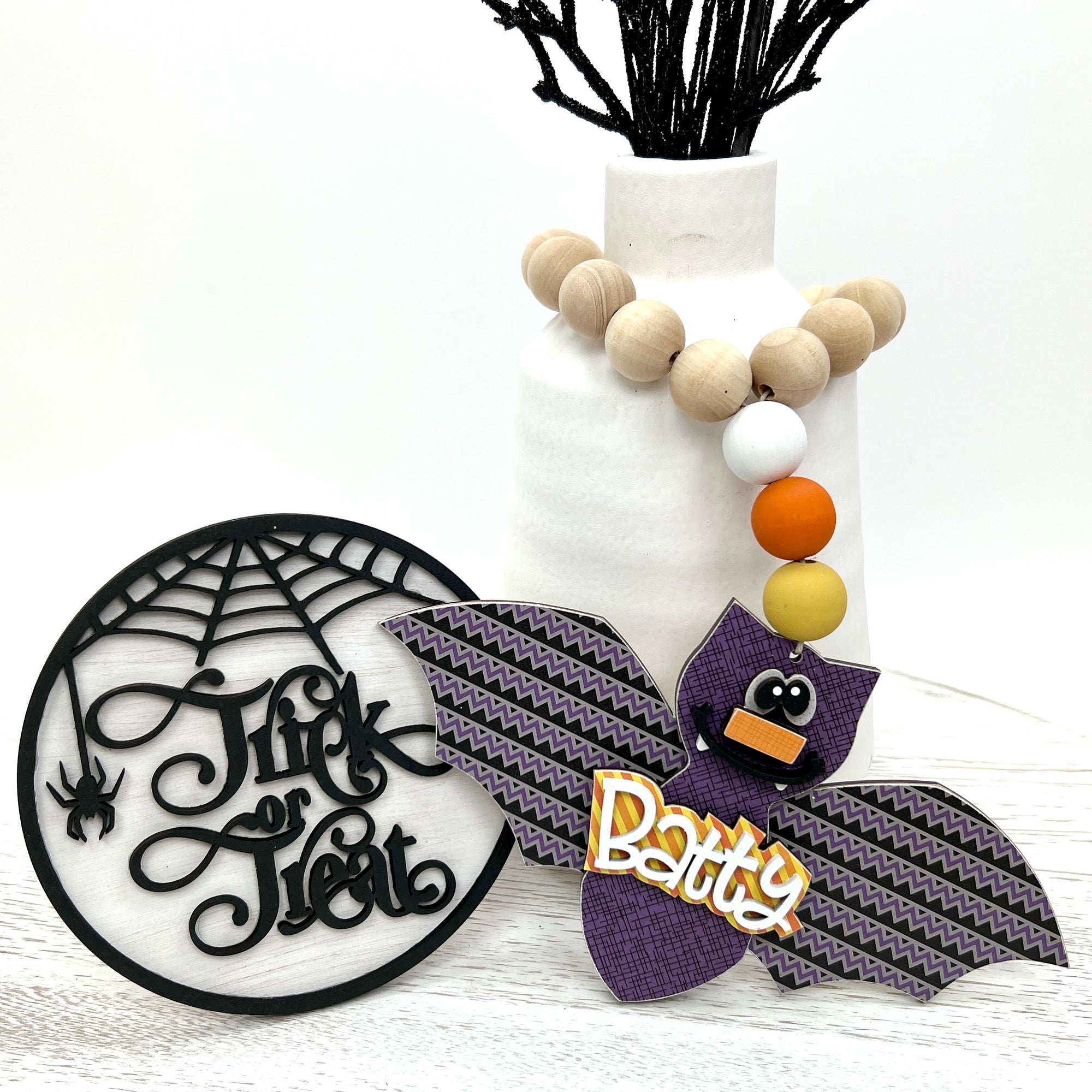 Wood trick or treat sign and wood beaded bat garland for Halloween decorations and Halloween themed tiered trays