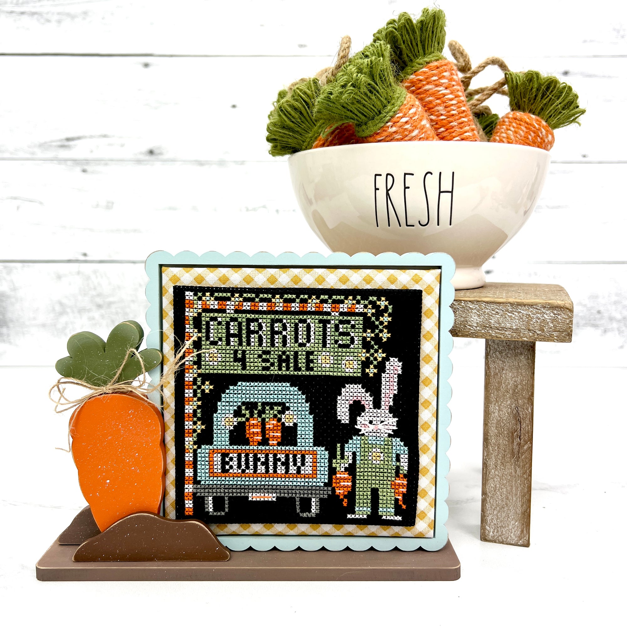 Wood cross stitch display frame backer with a sprouting carrot
