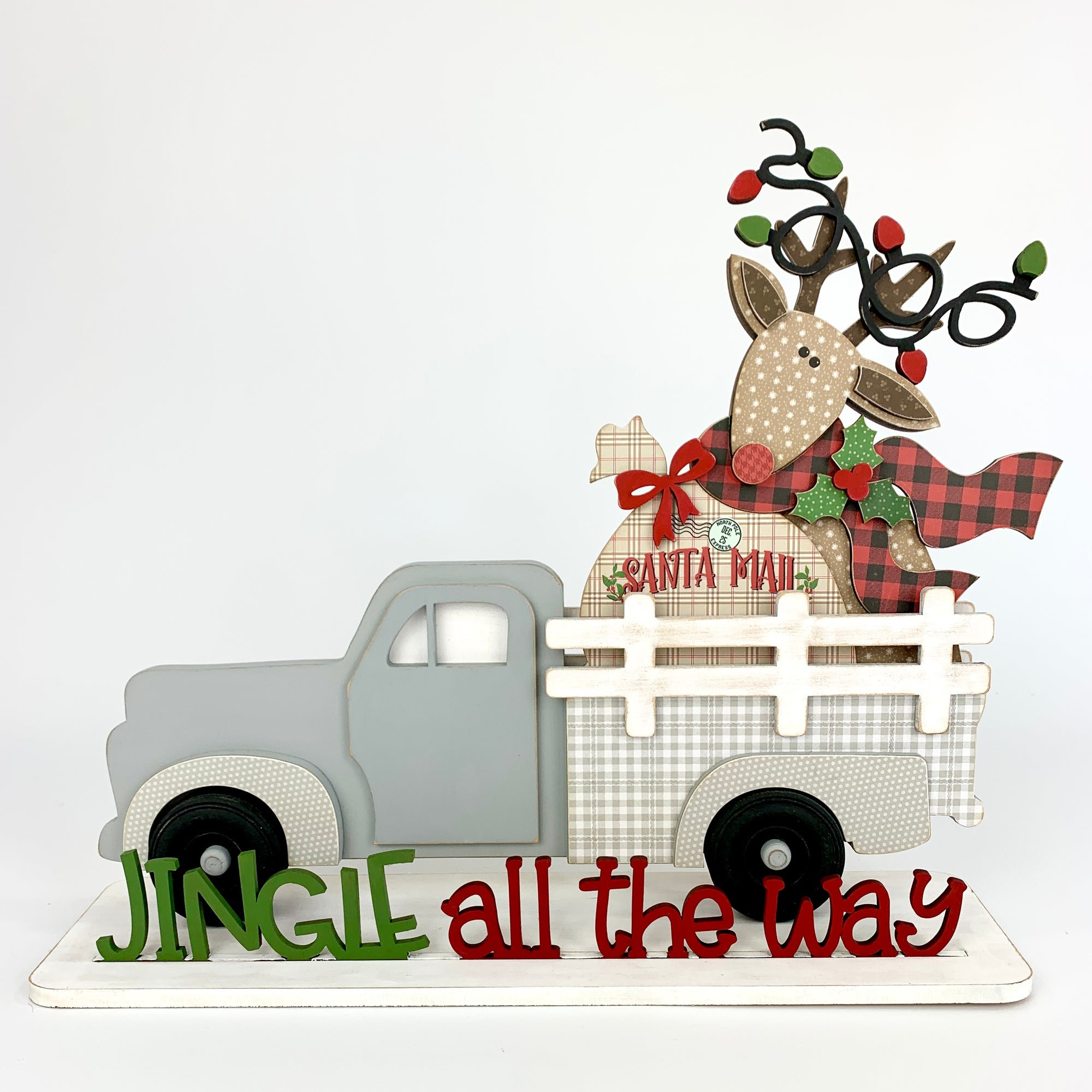 Christmas reindeer interchangeable pick up truck insert. Changing seasonal wood decor Christmas reindeer wood craft kit. Reindeer holding santa mail sack with Christmas lights wrapped around his antlers.