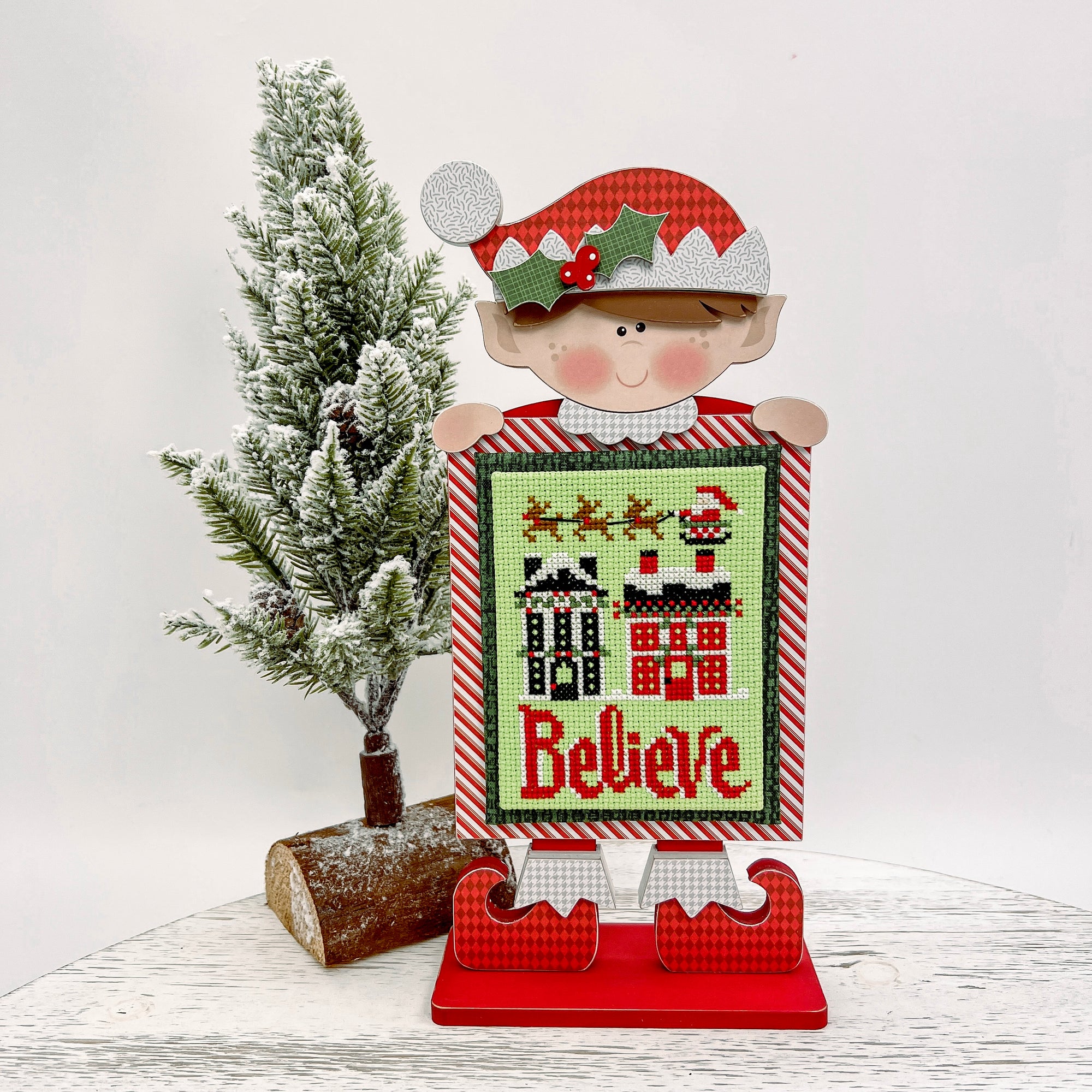 Christmas elf wood decor for displaying a finished cross stitch or needlepoint.
