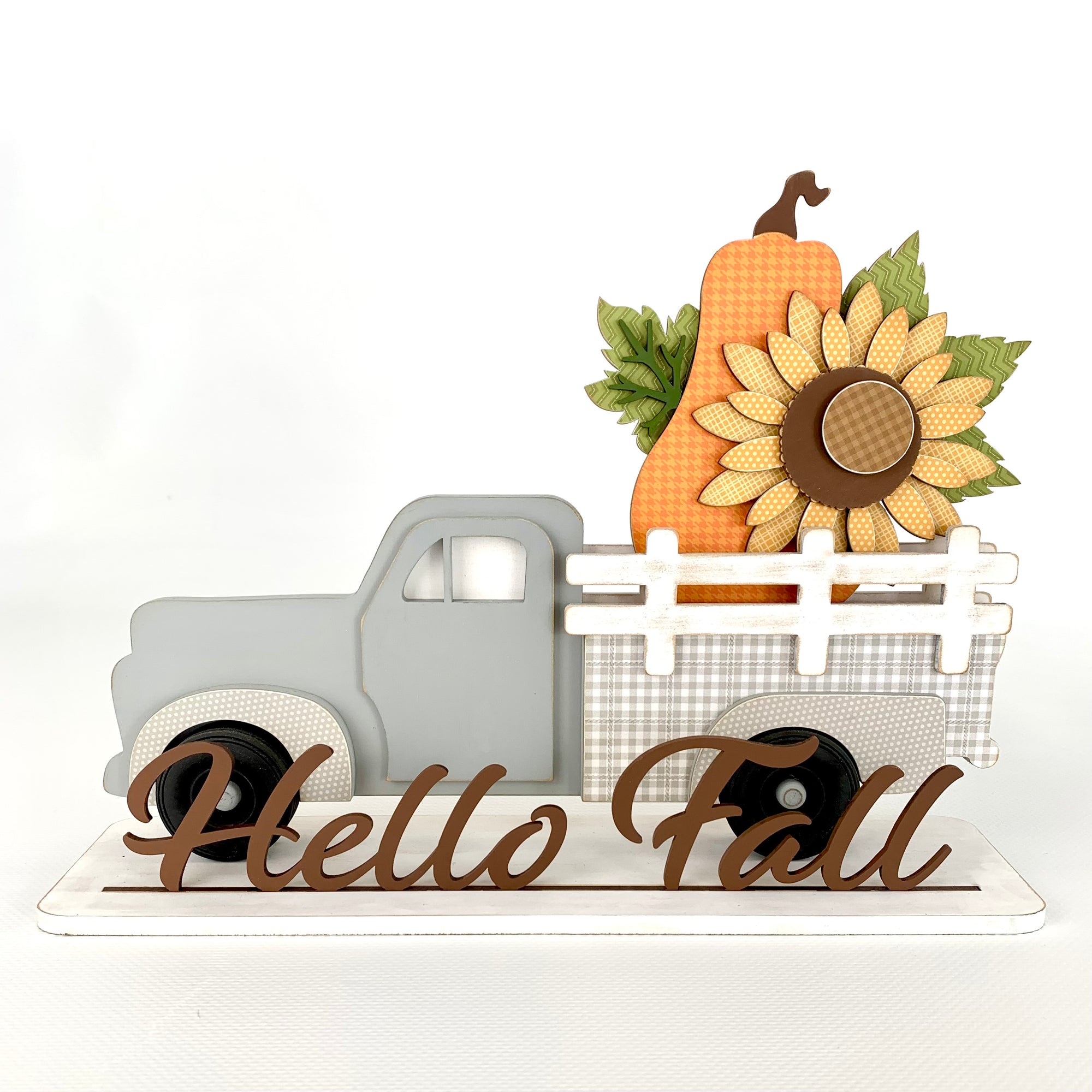 Interchangeable pick up truck with removable inserts to change monthly or seasonally.  Truck shown with a fall sunflower and orange pumpkin. This is a wood decor craft kit.