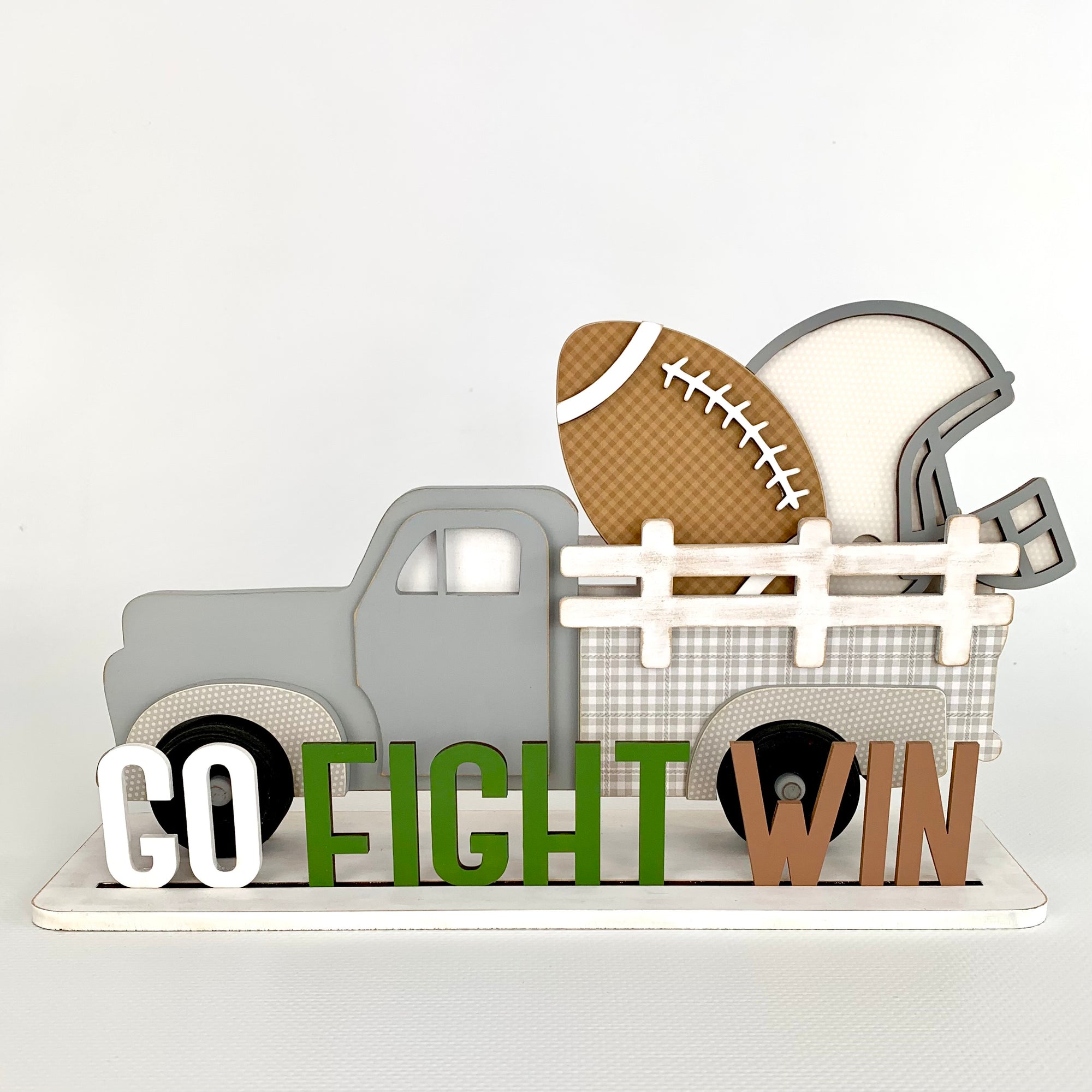 Interchangeable wood pick up truck that has inserts in the back to change our seasonally or monthly.  Truck shown has a football themed insert with a football, helmet, and go fight win title. 