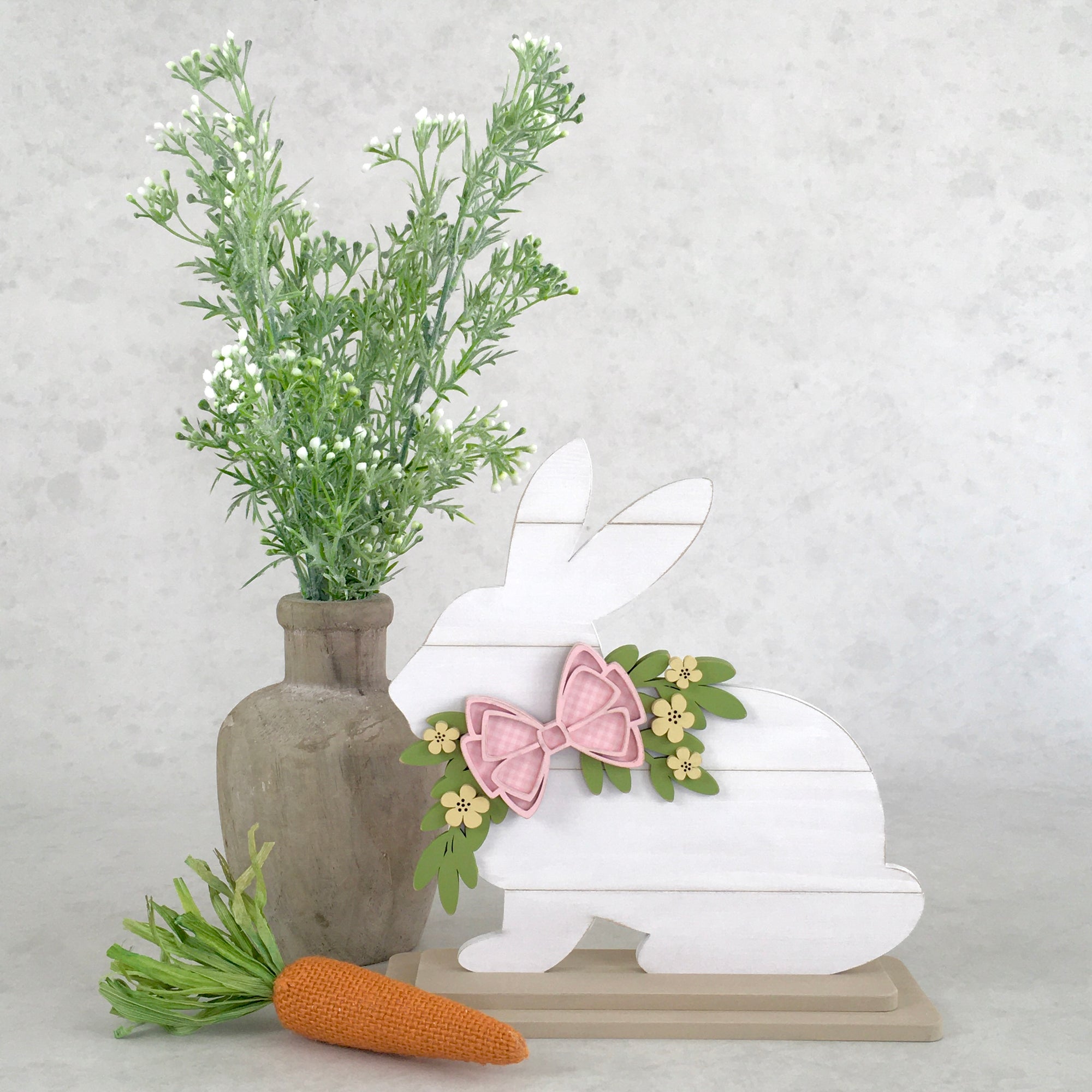 Shiplap Easter bunny decorations.  White easter shiplap bunnies with bows and greenery.  Sitting and Standing Easter bunny decorations.  Wood Easter decorations.