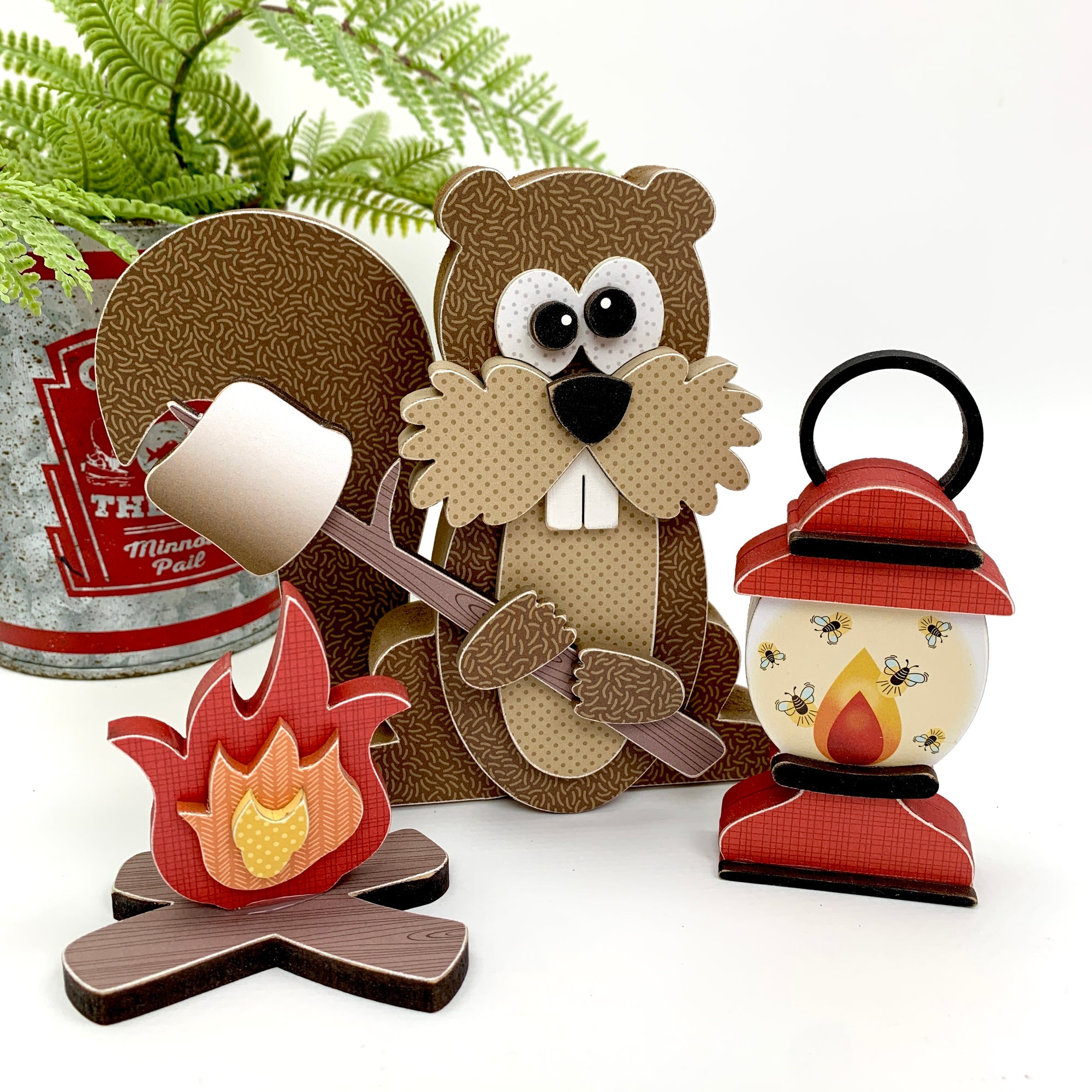 wood decor kit of a Woodland squirrel holding a marshmellow over a campfire with a lantern 