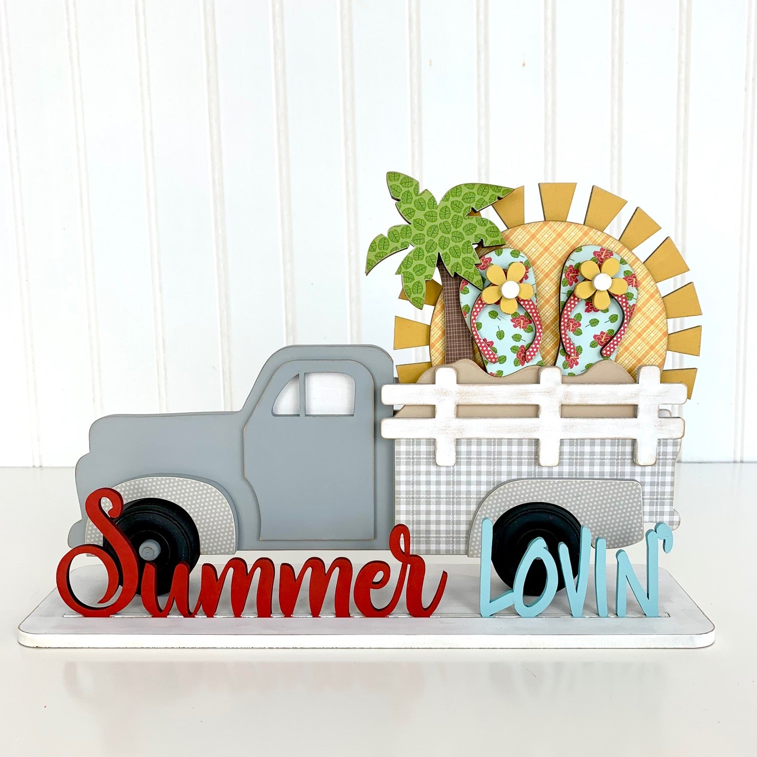 Wood pick up truck insert for summer. Summer Lovin phrase with a sun, palm tree, sand, and flip flops. Changing monthly or seasonally truck insert. 