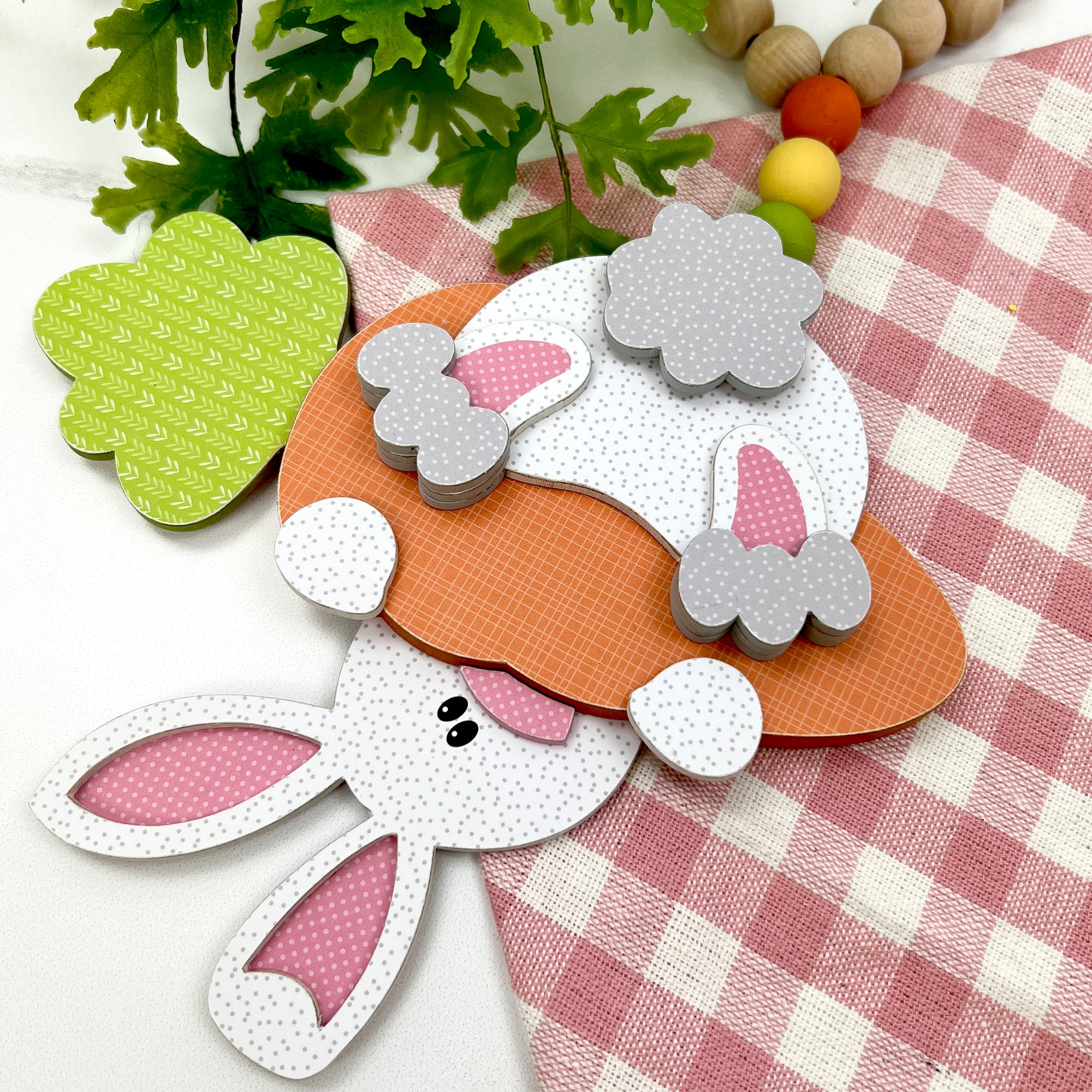 Bunny hanging upside down with wood beads for easter decorations