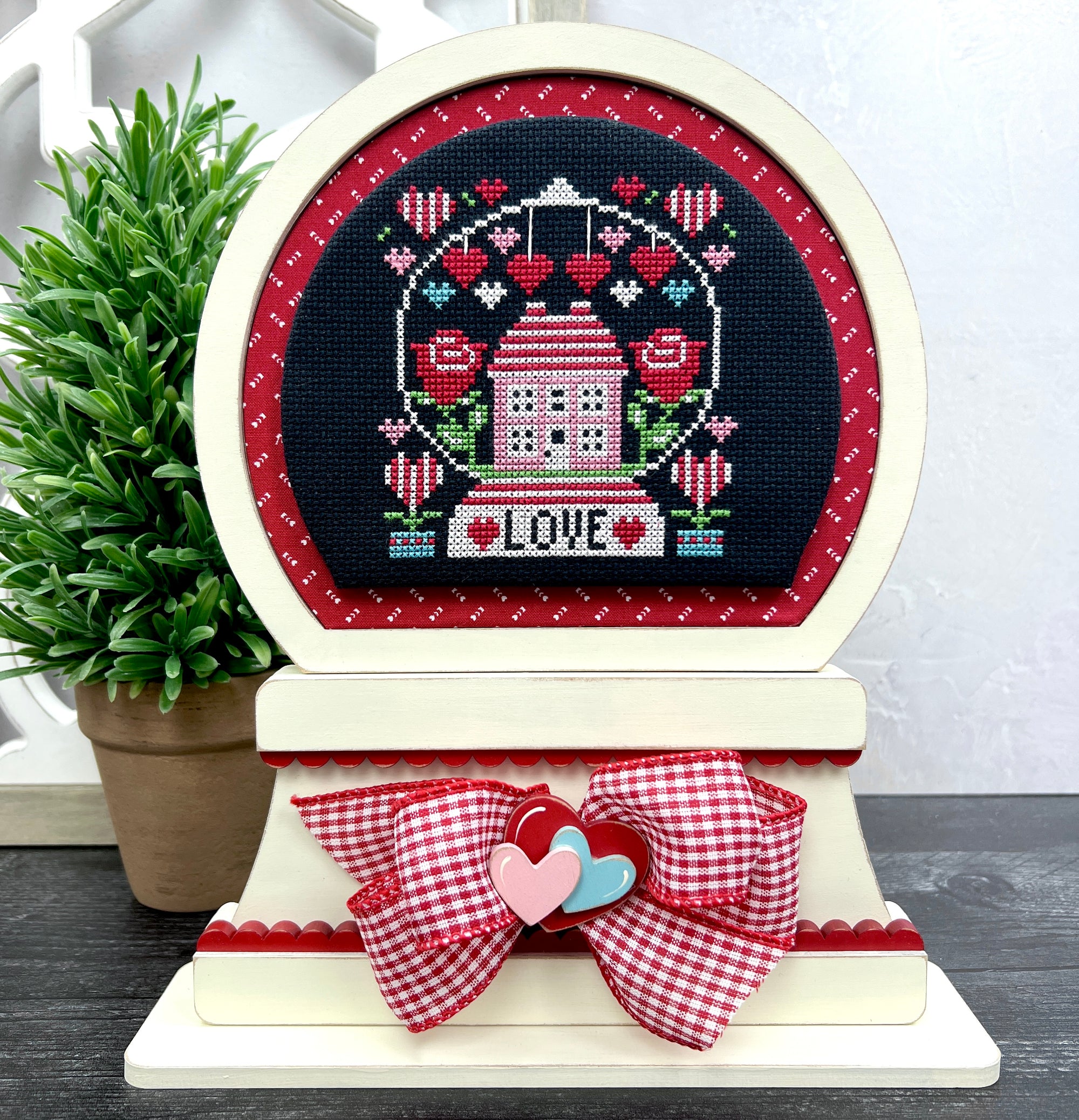 Stitching With the Housewives Snowed in -love dapper doodad cross stitch on a wood snow globe