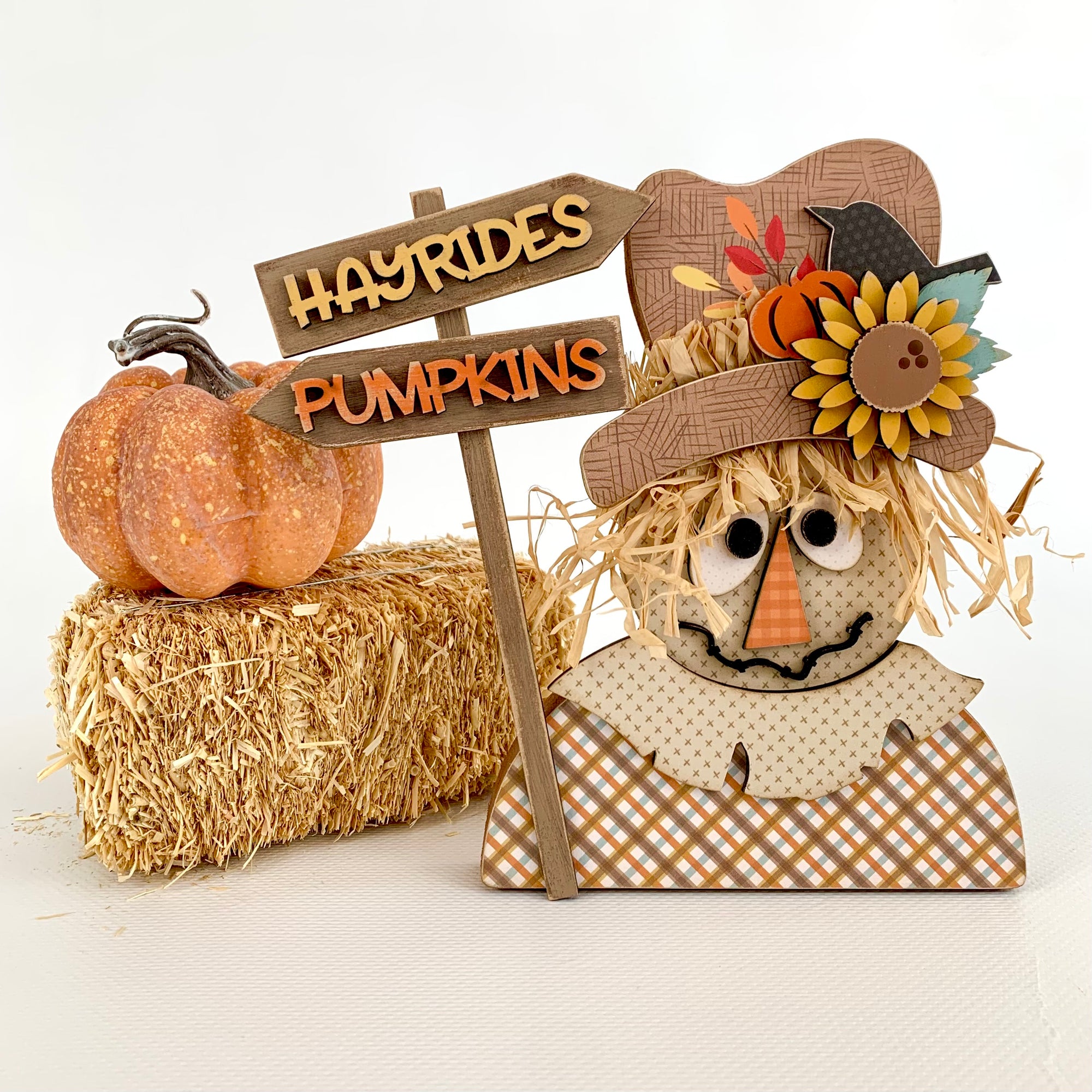 Wood scarecrow home decor DIY kit for tiered trays, shelves, and mantels.  Scarecrow holding a pumpkins and hayrides sign.  Fall wood decor decorations.  Thanksgiving scarecrow decoration.